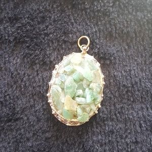 Green stone gold tone pendant